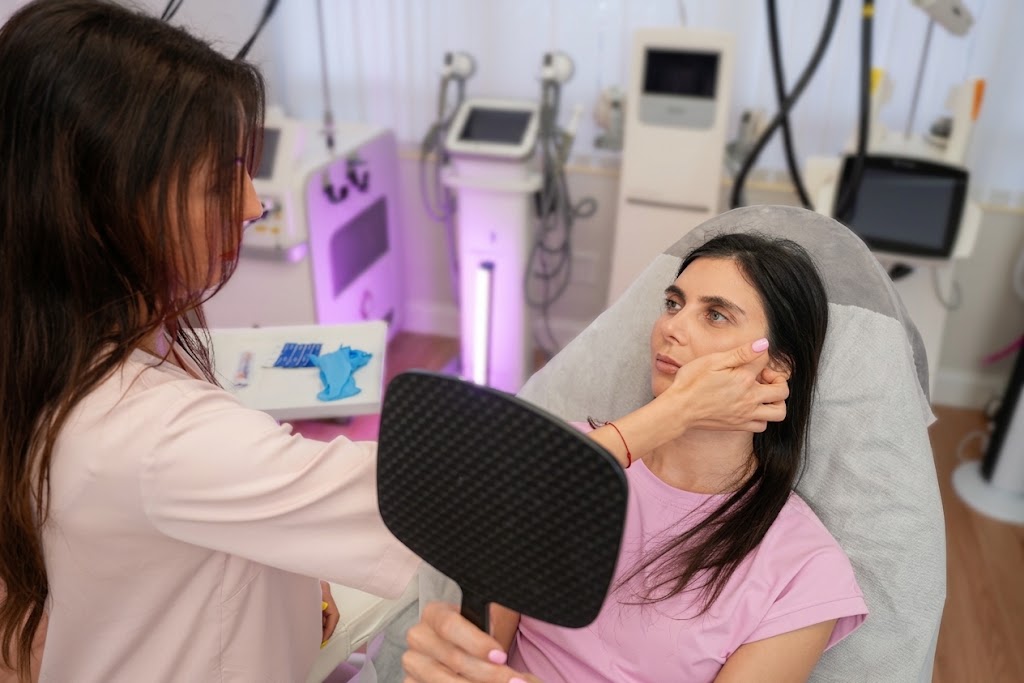 Yulia thoughtfully assessing a client during an aesthetic consultation